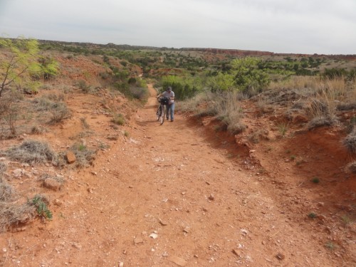 pushing the bike uphill at caprock canyon eagle trail pushing the bike uphill at caprock canyon eagle trail