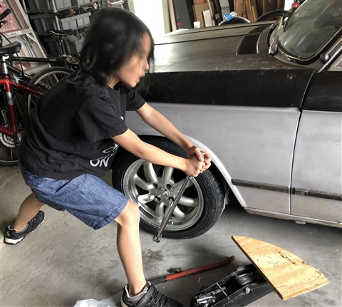 torquing the lug nuts with a breaker bar 