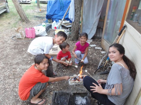 kids grilling marshmallows in texas june heat