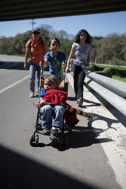 under mopac on a stroller holding a kite under mopac on a stroller holding a kite