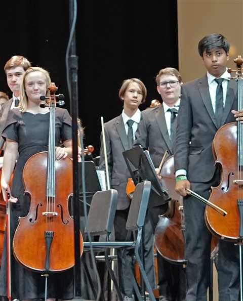 annoyed son doesn't like having picture taken orchestra