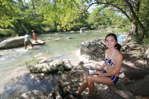 reading a book in the shade along the blanco river reading a book in the shade along the blanco river