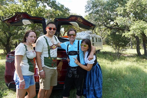 tesla x and airstream in the texas hill country with lederhosen
